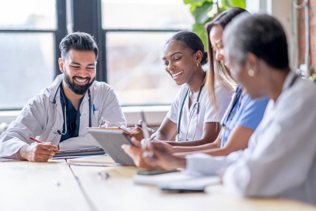 A group of doctors sitting around a table.