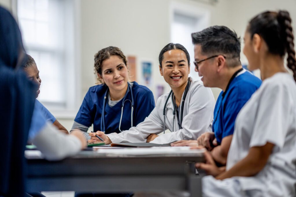 A group of doctors sitting around a table.